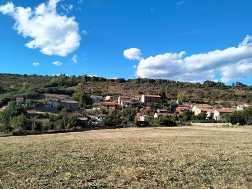 a town on a hill with a field in the foreground at Casa Manuel y Ana María. in Llombera