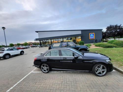 a black car parked in a parking lot at River View Two Bed Room Luxury Apartment in Thamesmead