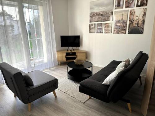 a living room with a couch and a chair at Studio JadOr gare du Bourget Paris aeroport Charles de Gaulle in Le Bourget