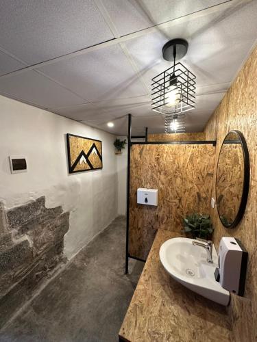 a bathroom with a sink and a wall at CASA CRISTOBAL Siete Cuartones in Cusco