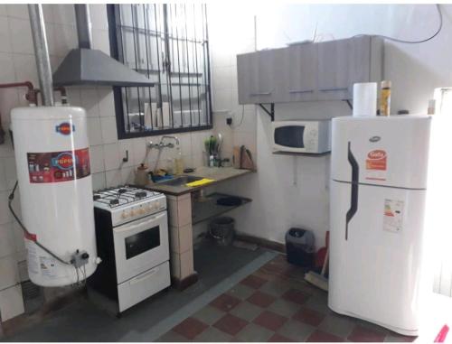 a small kitchen with two refrigerators and a stove at Loft centrico in Villa Cubas