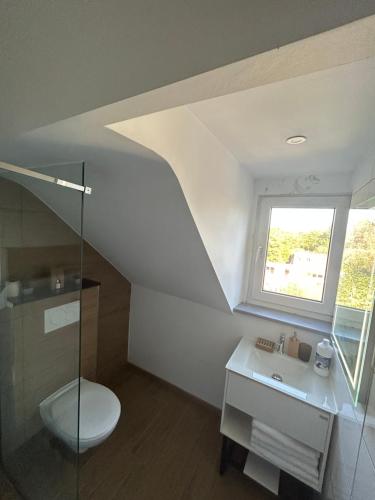 a bathroom with a toilet and a sink and a window at Elegance & Comfort Brand New Apartment near to Atomium in Brussels