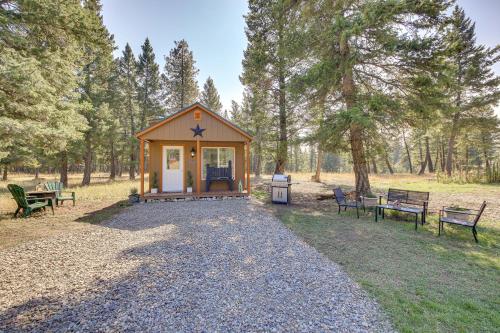 a small cabin in the middle of a park with benches at Eureka Vacation Rental Steps to Creek and Fishing! in Eureka