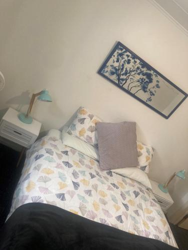 a bedroom with a bed with a laptop on it at Mountain View Backpackers in Wanaka