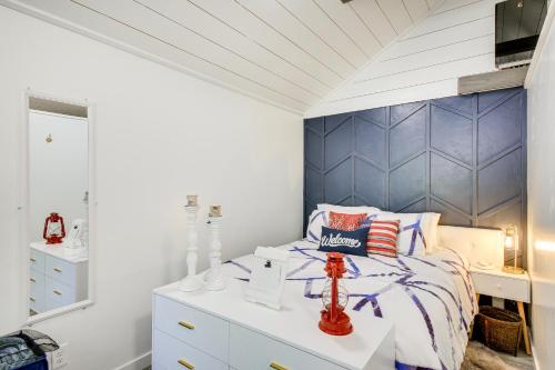 a bedroom with a bed with a blue headboard at Eureka Vacation Rental Steps to Creek and Fishing! in Eureka