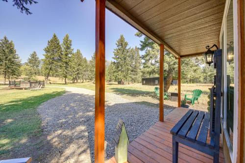 a porch with a blue bench on a house at Eureka Vacation Rental Steps to Creek and Fishing! in Eureka