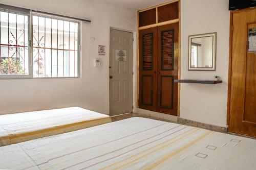 Ένα ή περισσότερα κρεβάτια σε δωμάτιο στο Hotel Posada Edem