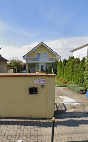 a house with a sign on the side of it at Cozy Room with garden in Bratislava in Bratislava