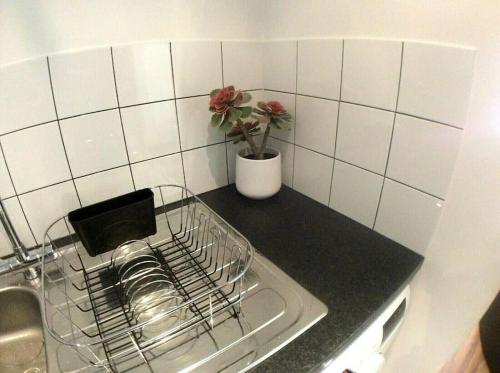a kitchen counter with a drying rack next to a sink at Igloo ViewPoint II City Centre Retreat + Parking in Sheffield