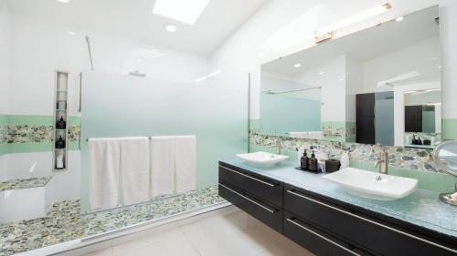 a bathroom with two sinks and a large mirror at Laguna Del Mar in George Town
