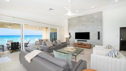 a living room with a couch and a television at Laguna Del Mar in George Town