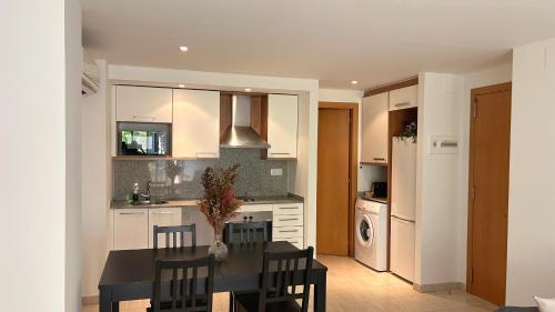 a kitchen with a table and chairs and a kitchen with a refrigerator at Céntrico y con balcón in Terrassa