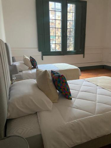 a group of three beds in a room at Casa Marina Huérfanos in Santiago
