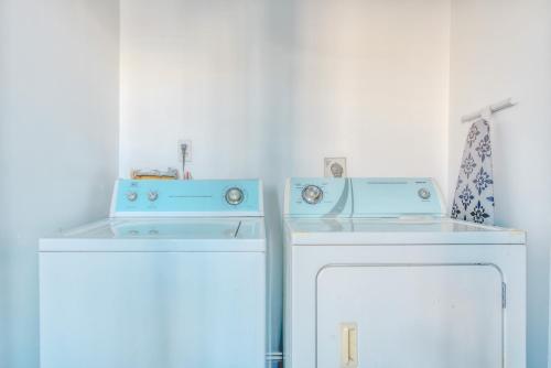 two blue washing machines sitting next to each other at The Stairway Suites - Convention Center in Philadelphia