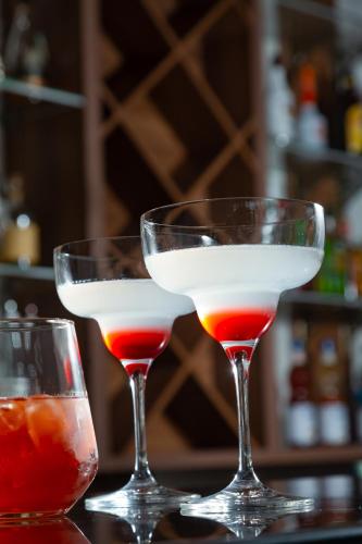 two cocktails in glasses sitting on a table at DoubleTree by Hilton Shymkent in Shymkent