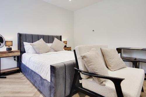 a bedroom with a bed and a couch and a chair at Mount Lodge in Bournemouth