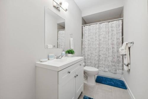 a bathroom with a sink and a toilet and a shower at Spacious 3Bedroom Duplex with Rooftop Deck! in Washington, D.C.