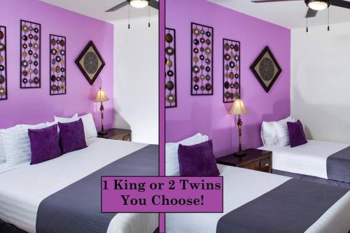 two beds in a room with purple walls at Luxury Vacation Rentals by Meridian CondoResorts in Scottsdale