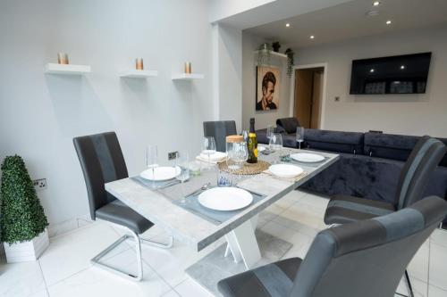a dining room with a table and chairs at Billie Island apartments in Slaithwaite