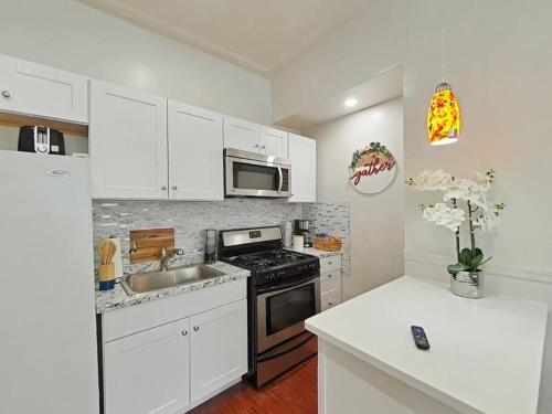 a kitchen with a sink and a stove top oven at Elegant 3Br Apt Yankee stadium in Melrose
