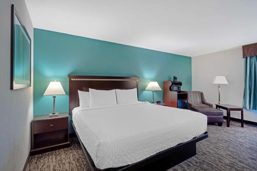 a hotel room with a bed and a chair at Best Western Plus Chicagoland - Countryside in Countryside