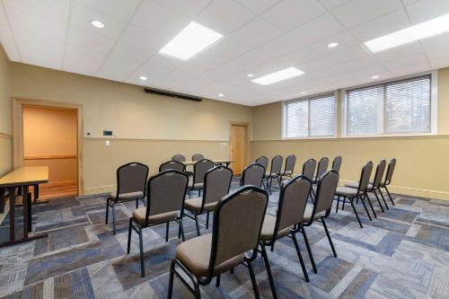 a conference room with chairs and a podium in it at Best Western Plus Windjammer Inn & Conference Center in Burlington