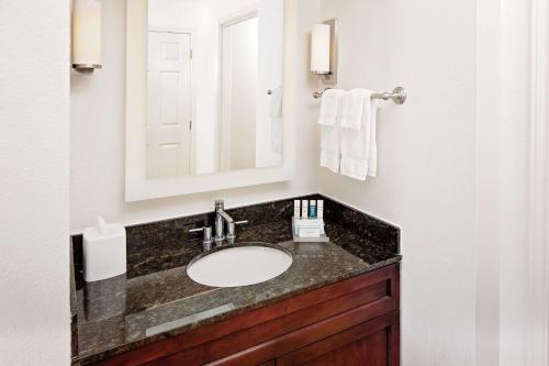 a bathroom with a sink and a mirror at Homewood Suites by Hilton Dallas Market Center in Dallas