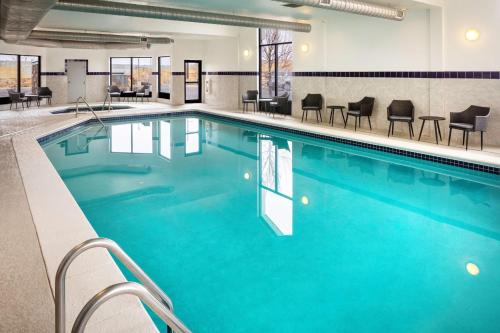 a large pool with blue water in a hotel room at Hampton Inn & Suites Parker in Parker