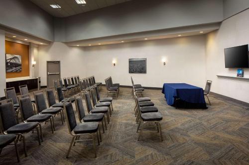 a room with chairs and a table and a screen at Hampton Inn & Suites Parker in Parker