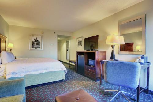 a hotel room with a bed and a television at Hampton Inn Portsmouth Central in Portsmouth