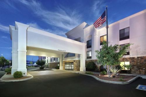 an exterior view of a hotel with an american flag at Hampton Inn & Suites Tucson East in Tucson