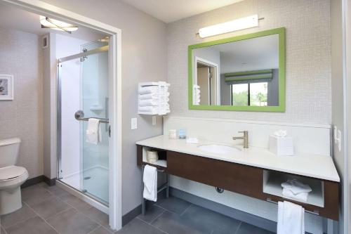 a bathroom with a sink and a mirror and a toilet at Hampton Inn & Suites Tucson East in Tucson
