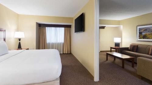 a hotel room with a bed and a couch at DoubleTree Suites by Hilton Hotel Cincinnati - Blue Ash in Sharonville