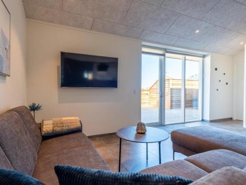 a living room with two couches and a tv at 6 person holiday home in Hvide Sande-By Traum in Hvide Sande