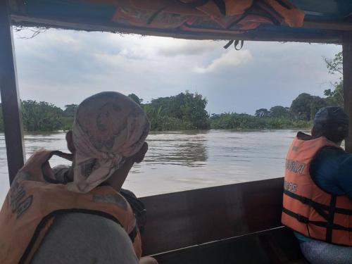 a group of people on a boat on a river at La Cachuela Lodge. 