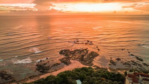 an aerial view of the ocean at sunset at Cala Luna Boutique Hotel & Villas in Tamarindo