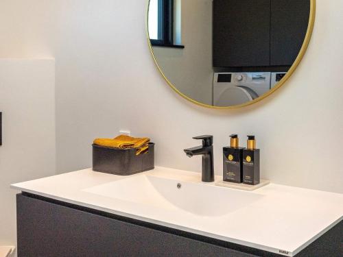 a bathroom with a sink and a mirror at Holiday home Løgstør IX in Løgstør