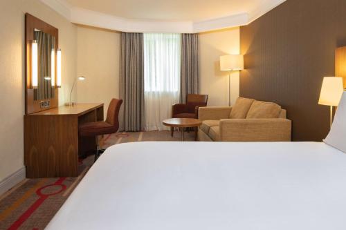 a hotel room with a bed and a living room at Orida Hotels Newbury in Newbury