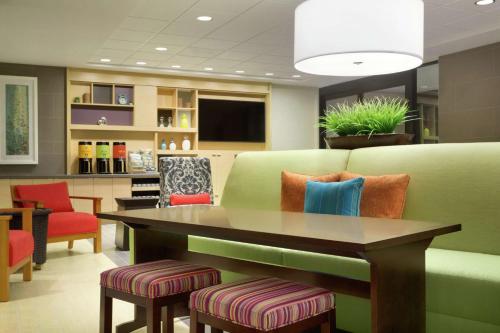 a waiting room with a couch and a table at Home2 Suites By Hilton Richland in Richland