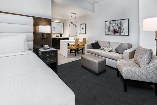 a hotel room with a bed and a living room at Embassy Suites by Hilton Houston West - Katy in Houston
