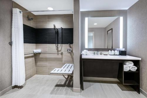 a bathroom with a sink and a shower at Embassy Suites by Hilton Houston West - Katy in Houston