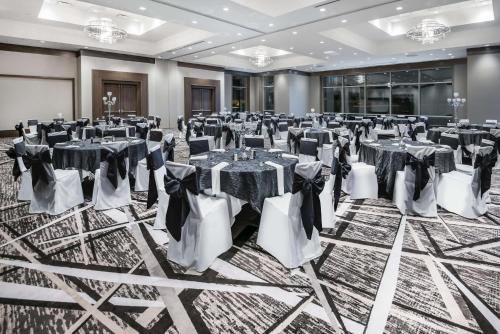 a banquet hall with tables and chairs in a room at Embassy Suites by Hilton Houston West - Katy in Houston