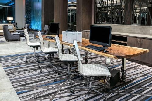 a row of desks and chairs with computers on them at Embassy Suites by Hilton Houston West - Katy in Houston