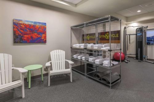 a room with chairs and a rack with towels at Home2 Suites by Hilton Kingman in Kingman