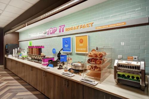 a bakery counter with pastries on it in a store at Tru By Hilton Raleigh Durham Airport in Morrisville