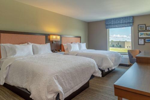 a hotel room with two beds and a window at Hampton Inn Bourbonnais Kankakee in Bourbonnais