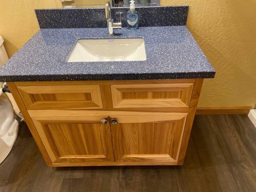a bathroom sink with a granite counter top at Cedar Mountain -Suite B in Grants Pass
