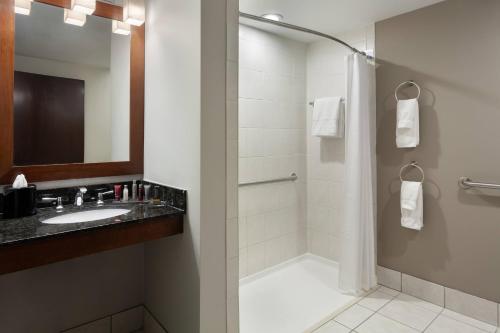 a bathroom with a sink and a shower at DoubleTree by Hilton Minneapolis Airport, MN in Bloomington