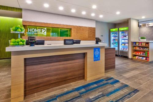 a lobby of a home store with a counter at Home2 Suites By Hilton Tucson Airport, Az in Tucson