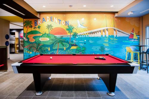 a pool table in a room with a mural at Tru By Hilton Bradenton I-75, FL in Bradenton